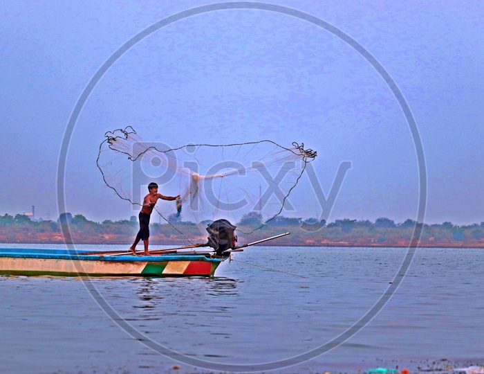 fishermen spinning his kind of web for livelihood !
