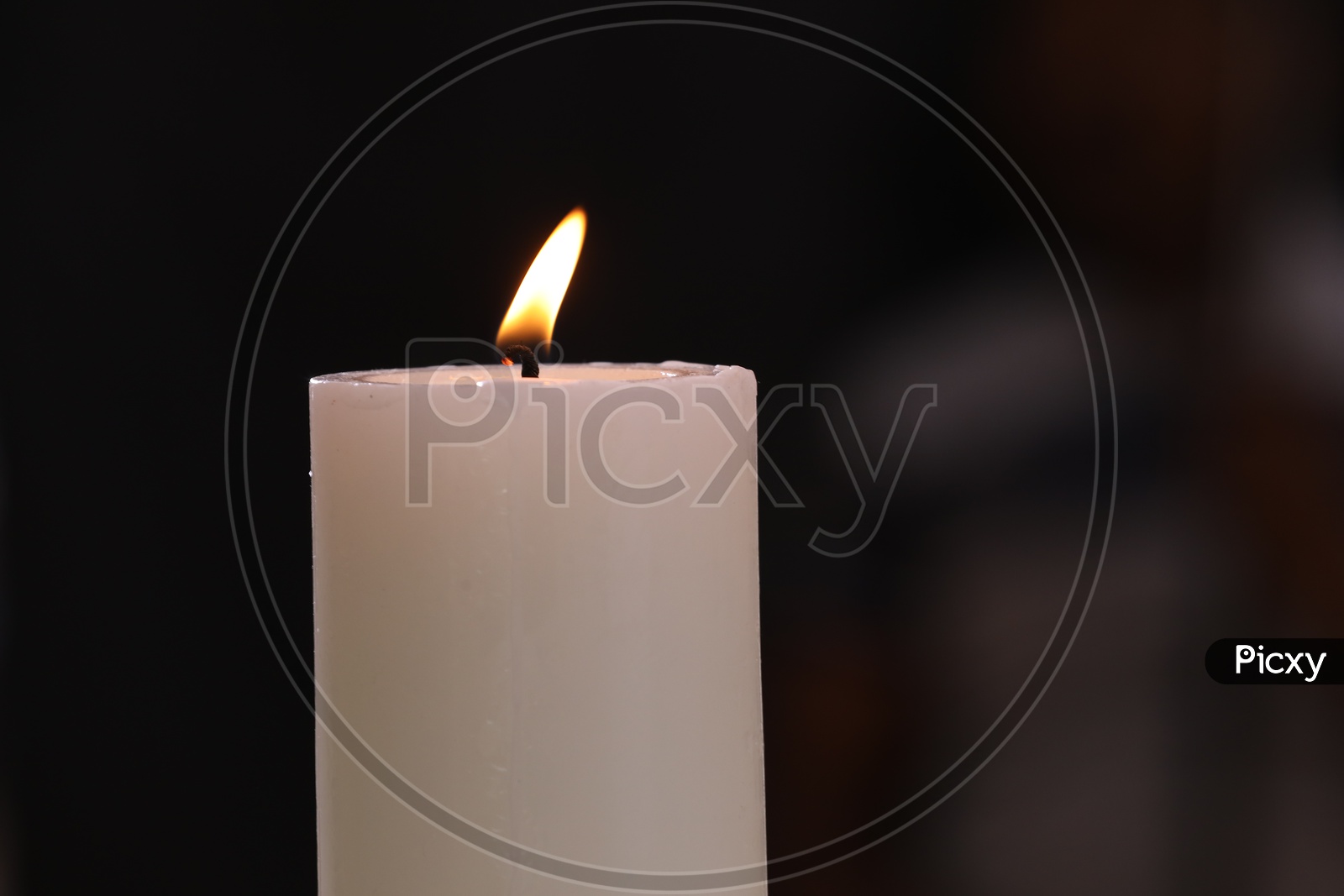 Lit Candle On an Isolated Black Background