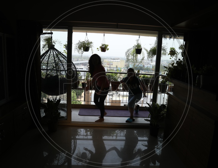 Silhouette Of Young Girls Or Ladies  in a  Balcony Of a Flat