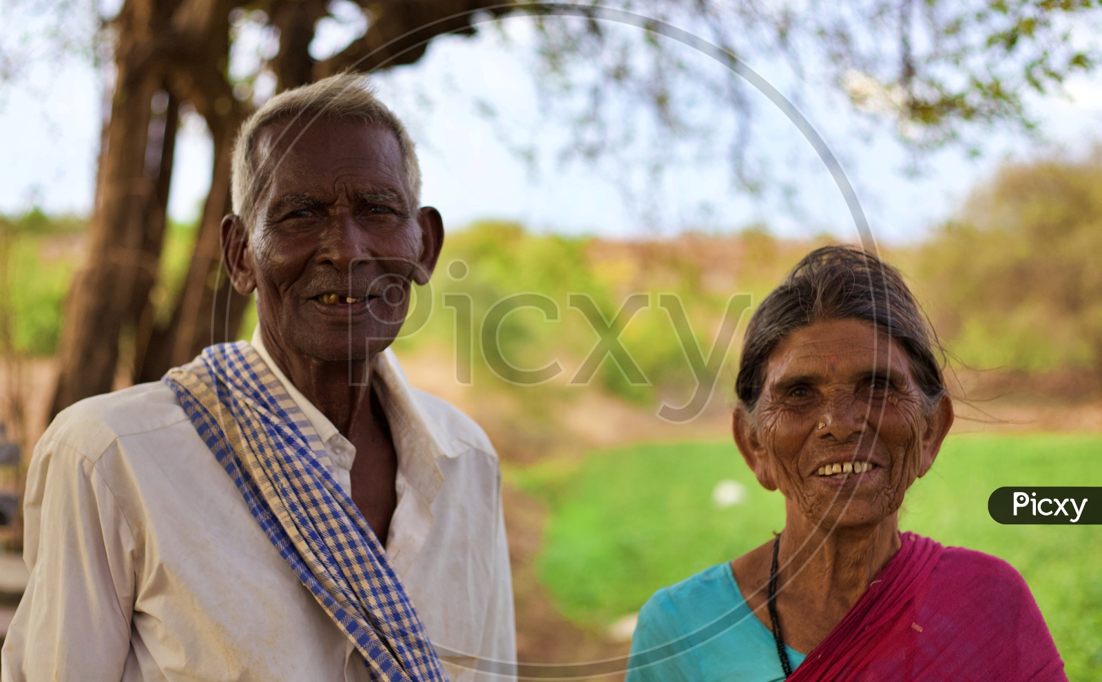 An old smiling farmer couple.
