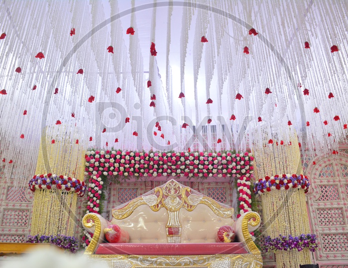 Decorated  Stage  With  Fresh Flowers and Sofa On Stage For Couple  in a Convention Center