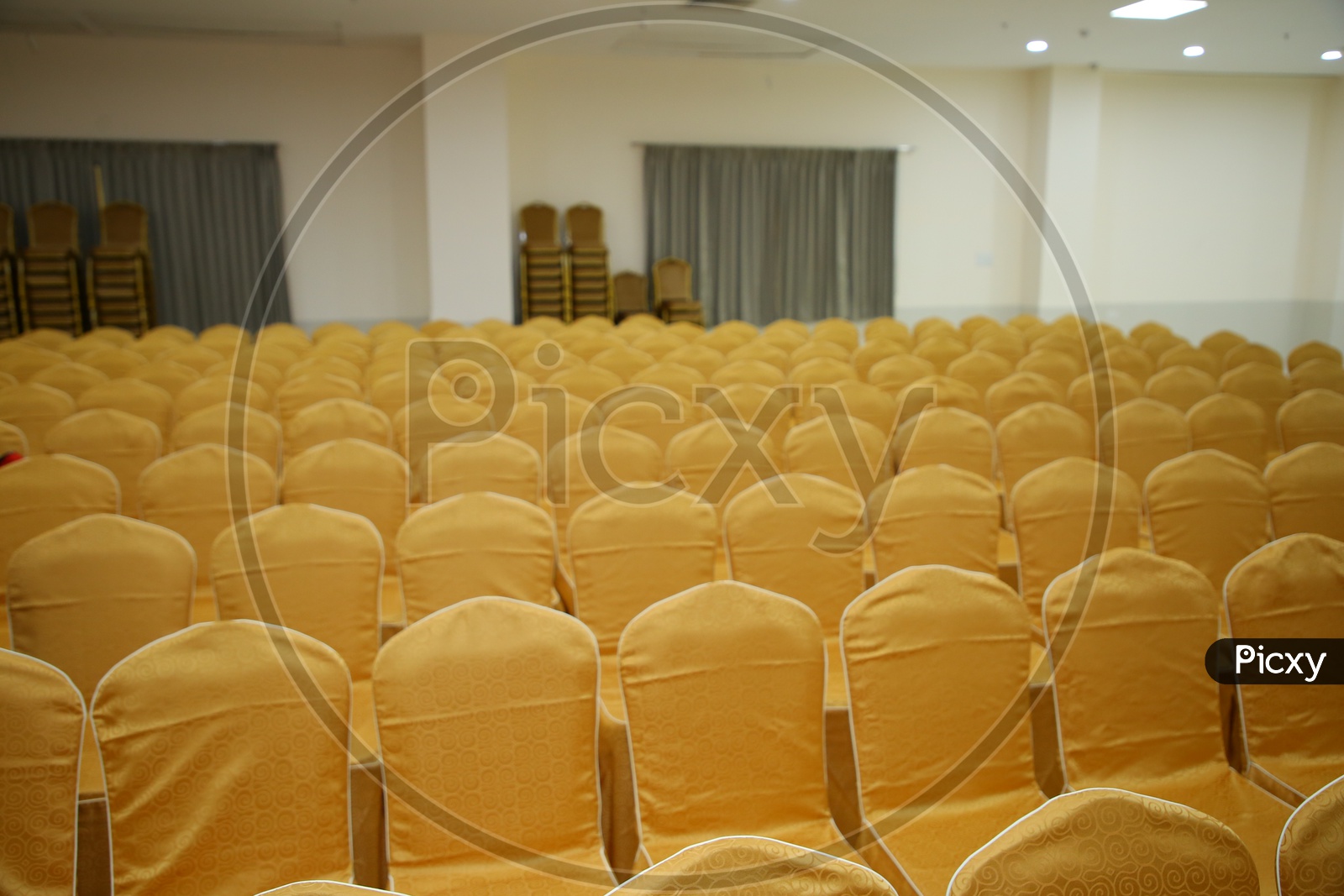 Chairs Arranged In  Rows In a  Convention Hall For a Event