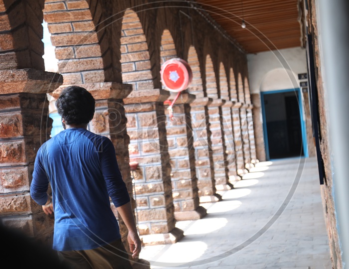 A Man Walking Alone In a School corridor Or Solitude