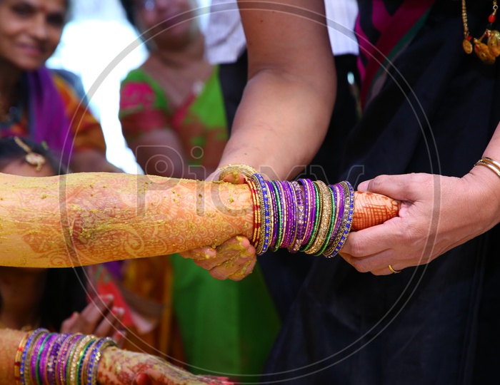 Relatives Applying Chandan Or Chandanam Or Haldi  Or Turmeric  Paste In Traditional Wedding Rituals