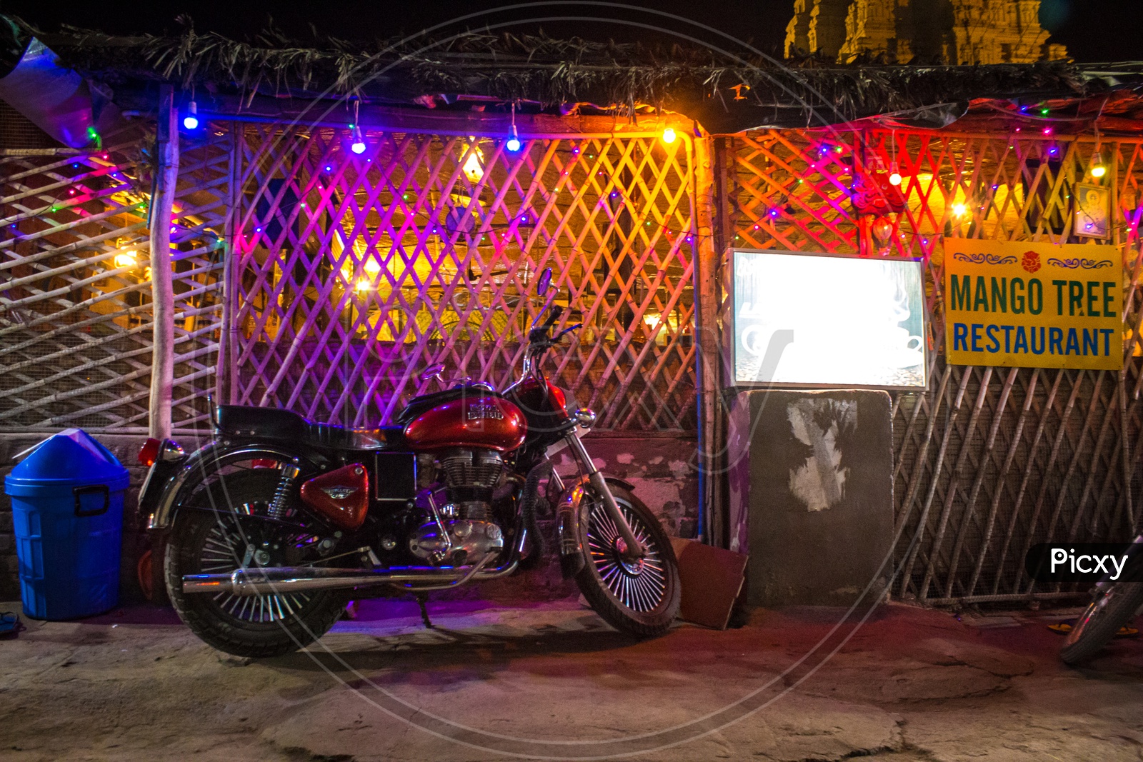 Bike parked at Mango Tree restaurant in Hampi during Night