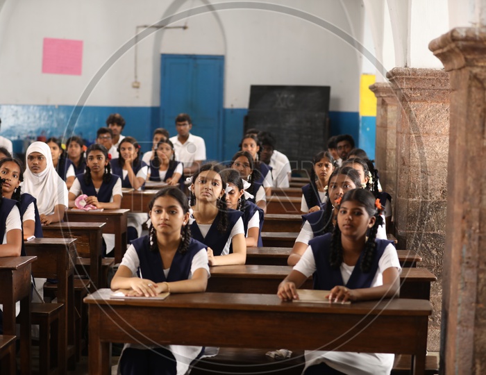 Students Sitting In a Classroom  Wearing Uniforms