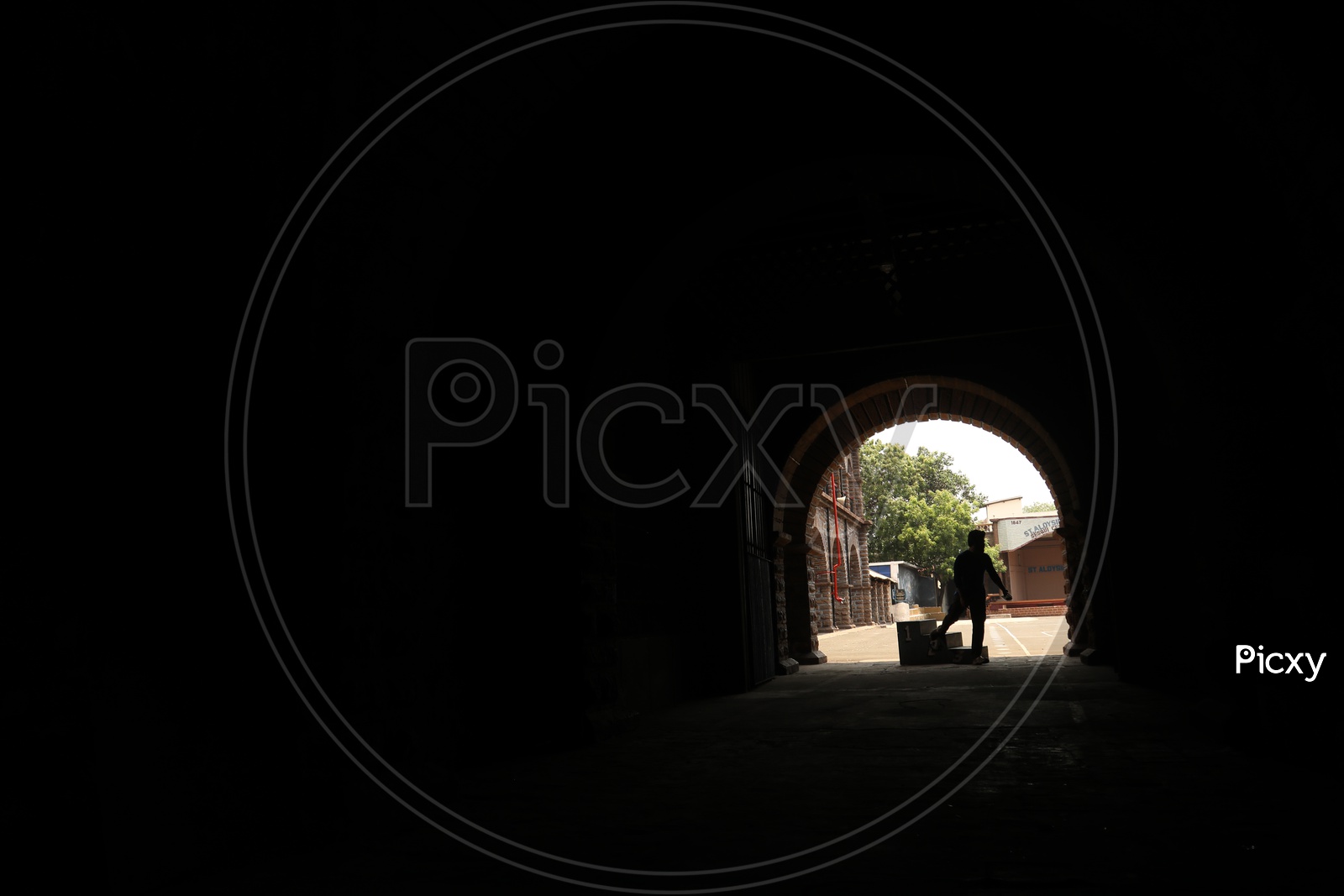 Silhouette Of a Man Standing  and Speaking in Mobile At  a Corridor