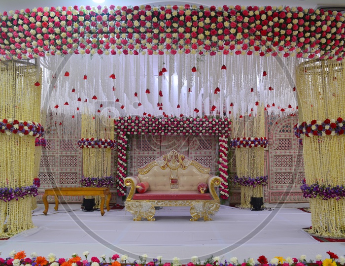 Decorated  Stage  With  Fresh Flowers and Sofa On Stage For Couple  in a Convention Center