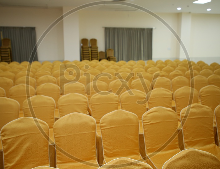 Chairs Arranged In  Rows In a  Convention Hall For a Event