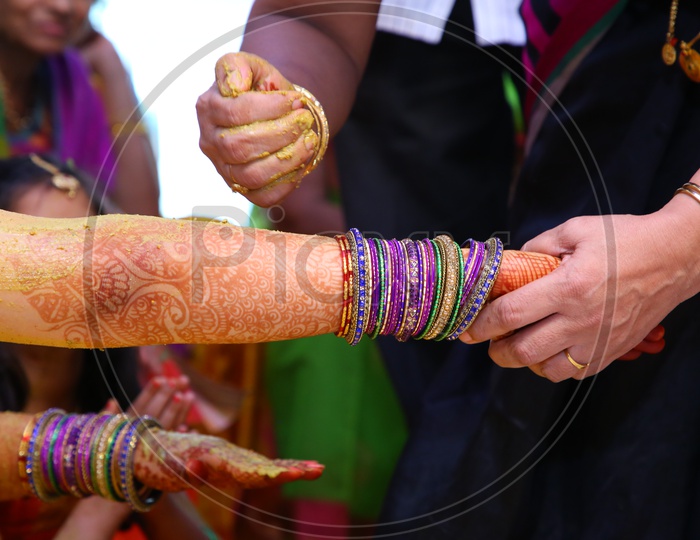 Relatives Applying Chandan Or Chandanam Or Haldi  Or Turmeric  Paste In Traditional Wedding Rituals