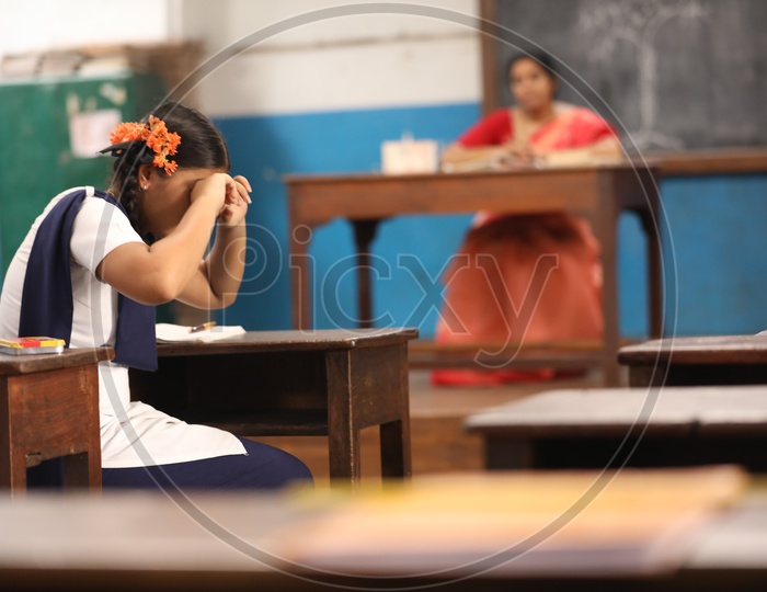 A School Student Or Girl Student Crying By Sitting in a Classroom