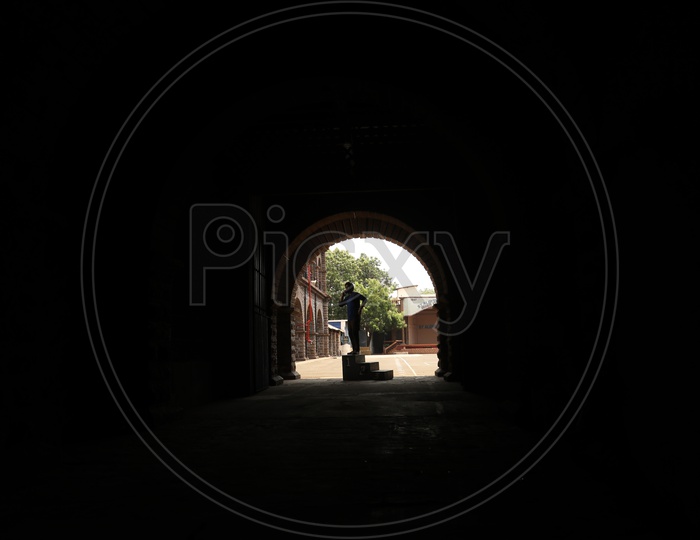 Silhouette Of a Man Standing  and Speaking in Mobile At  a Corridor