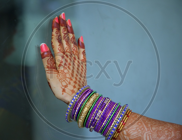 Indian Traditional Woman Hand Wearing  Bangles And  Mehandi Design On Hand Closeup