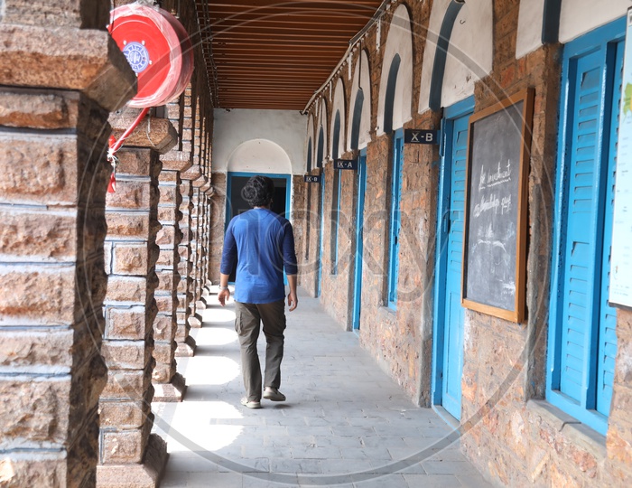 A Man Walking Alone In a School corridor Or Solitude