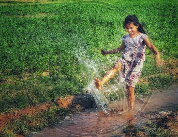 Cute girl playing with water in lake