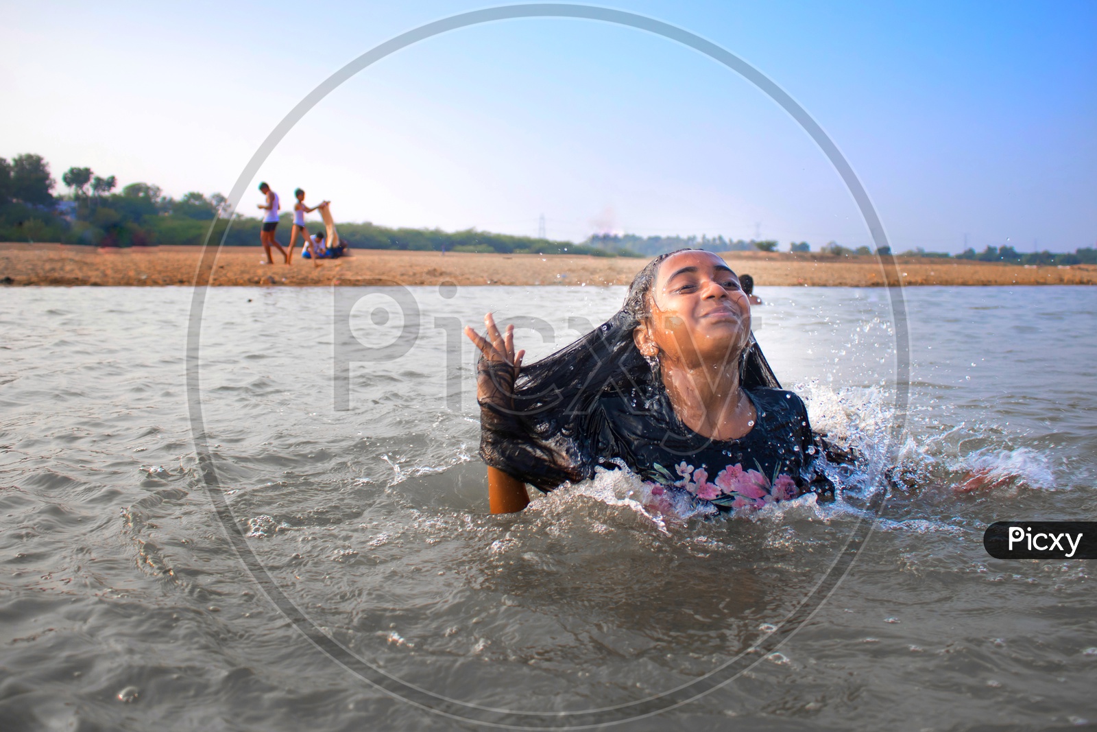 Cute girl playing with water in lake