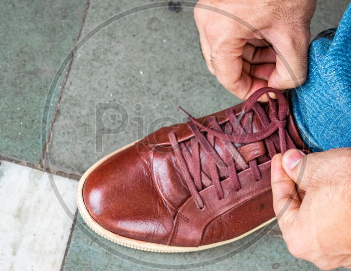 Tying shoelaces after getting it polished