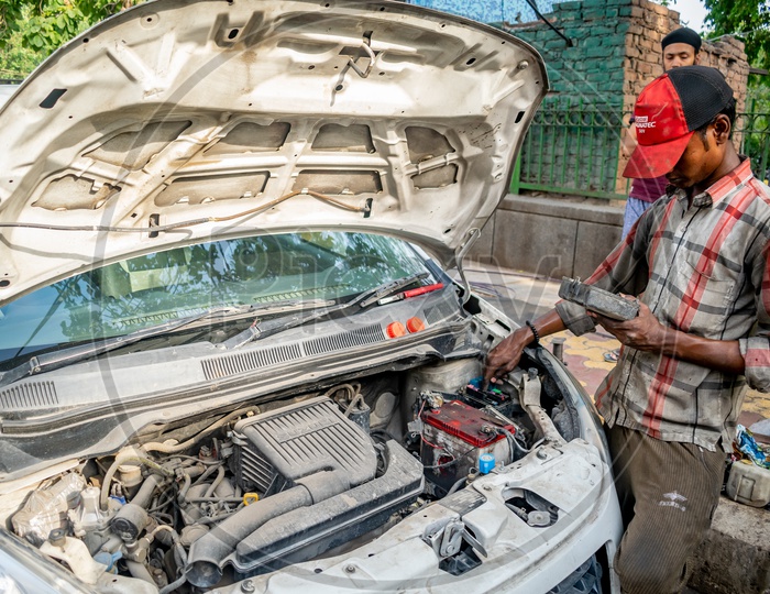A mechanic repairing a car