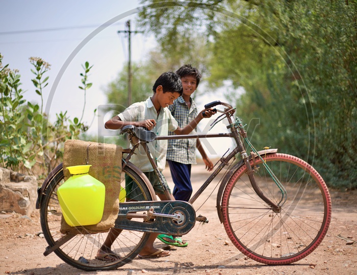 Kid carrying water to home.