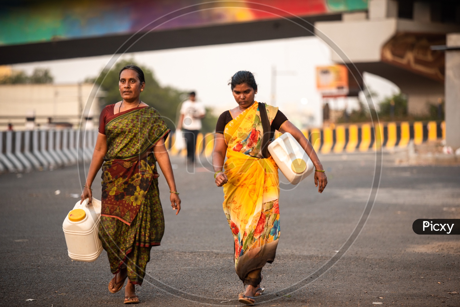Woman Carrying  Empty Water Cans or Vessels on Roads Of Hitech City