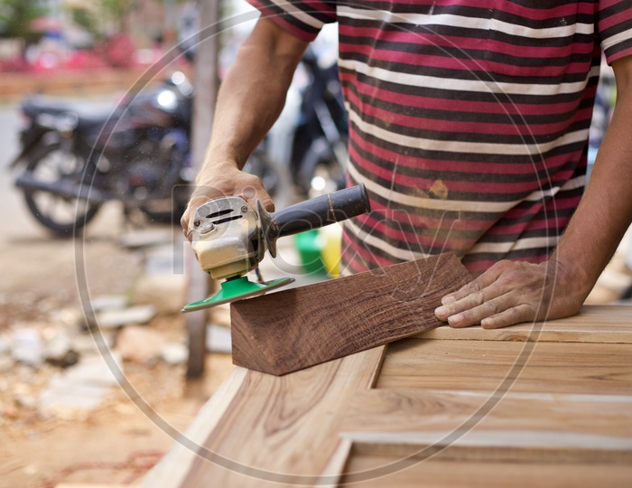 Carpenter grinding wood.