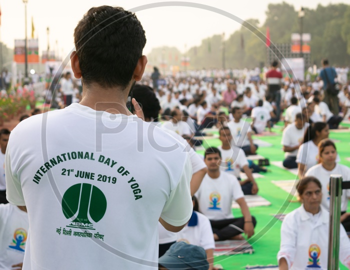 A man wearing t-shirt of International Day of Yoga, 2019