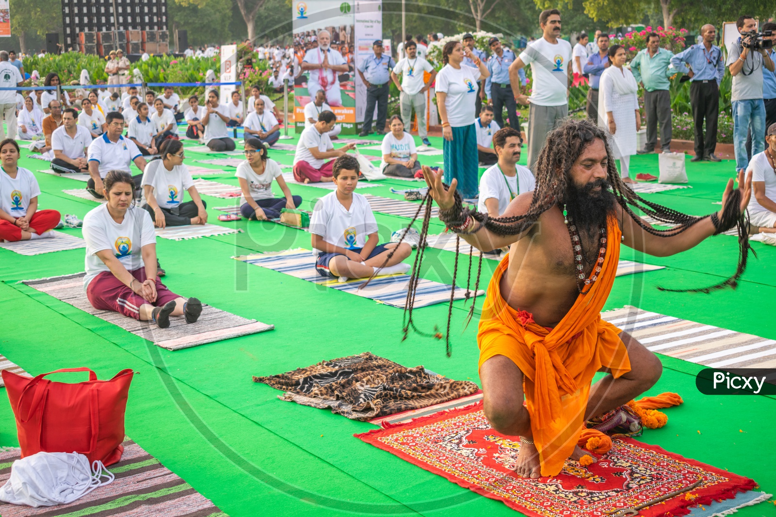 A sadhu(Baba) and others doing yoga asanas on the fifth International Yoga Day at Rajpath, Delhi