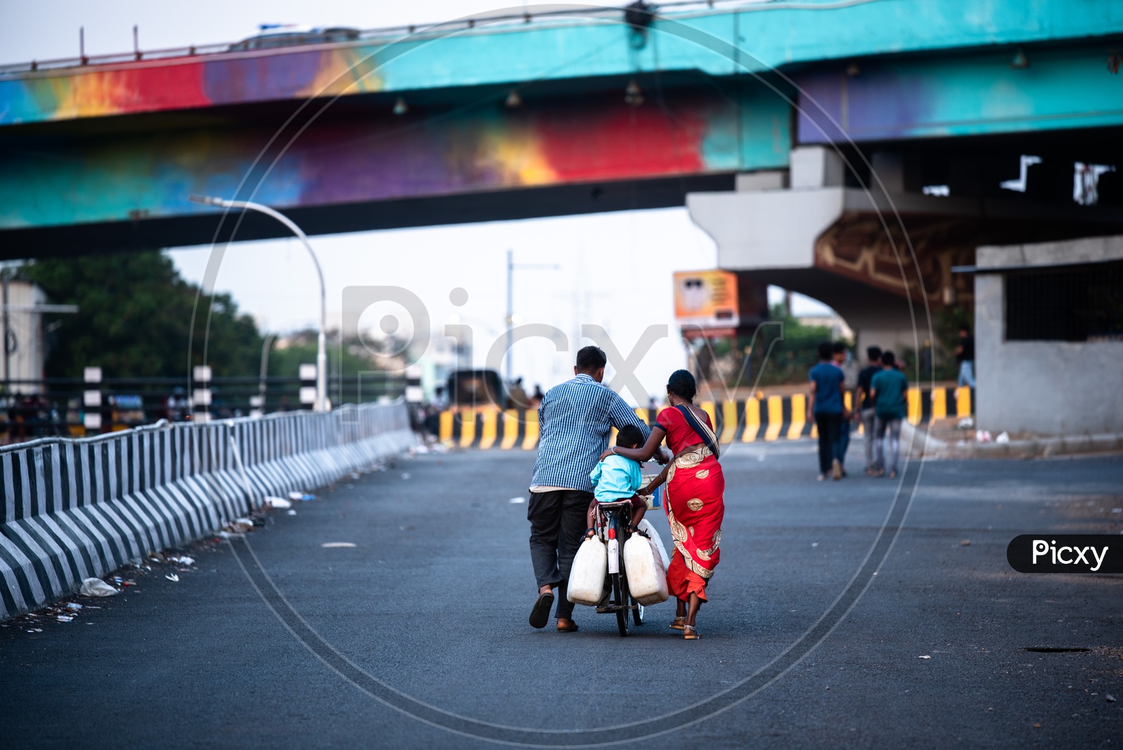 A Family Carrying Water Vessels In Bicycle At Hitech City  Roads