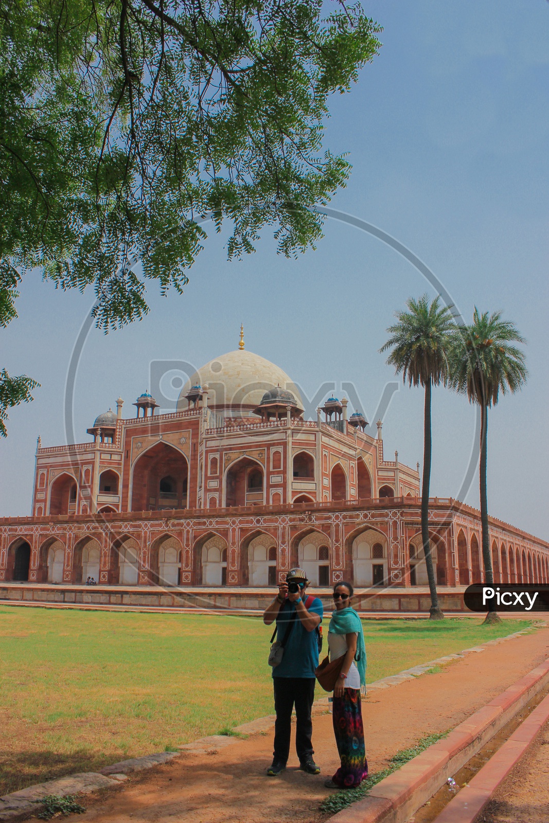 Two photographers capturing each other infront of the india's great historic architectural Humayun's tomb.