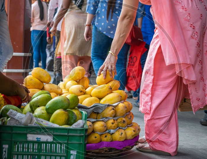 Woman buying mangoes