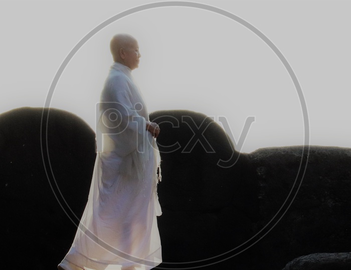 A Buddhist Wearing White Clothes At Ancient Buddhist temple At Ellora Caves