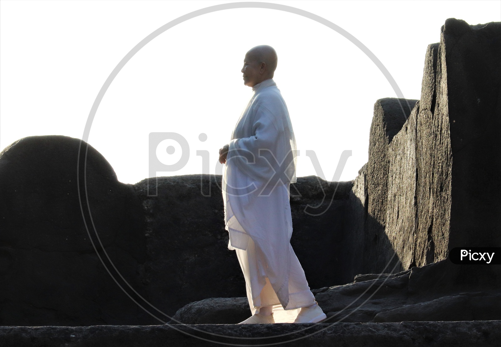 A Buddhist Monk In White Dress At Stone Carved   Ancient Buddhist Temple in Ellora Caves