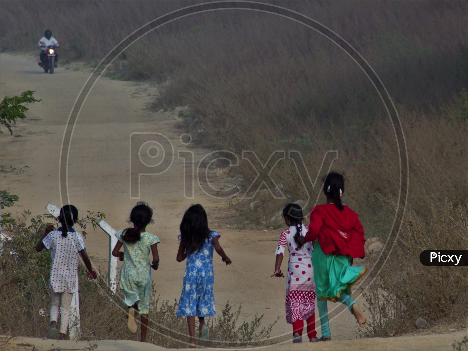 Image of Rural Village Girl Child Running as a Small Group in rural