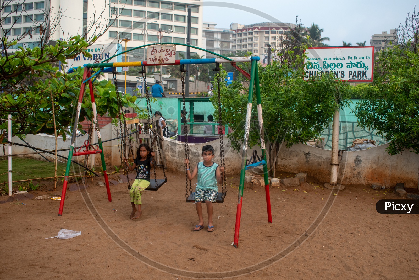 Kids playing swing at Children's park, Rama Krishna beach (R.K.Beach), Vishakapatnam/Vizag.