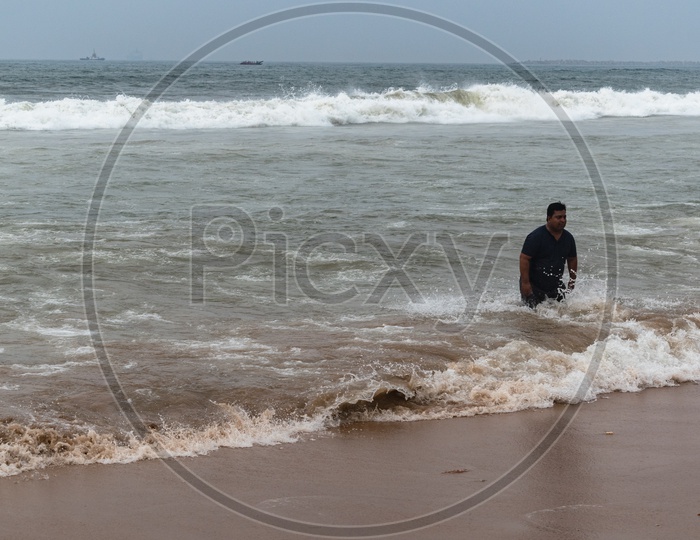 Person/man enjoying at Rama Krishna beach (R.K.Beach), Vishakapatnam/Vizag.