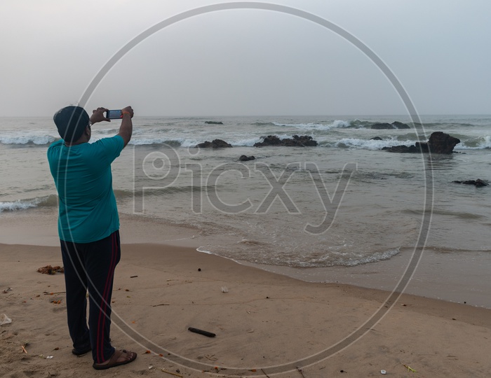 A Person/man clicking the picture of beach at Rama Krishna beach (R.K.Beach), Vishakapatnam/Vizag.