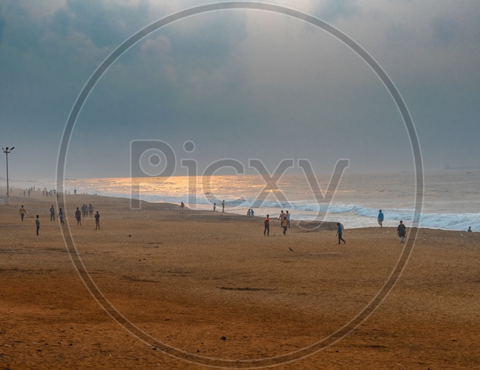 Group of young men playing cricket at Rama Krishna beach (R.K.Beach), Vishakapatnam/Vizag.