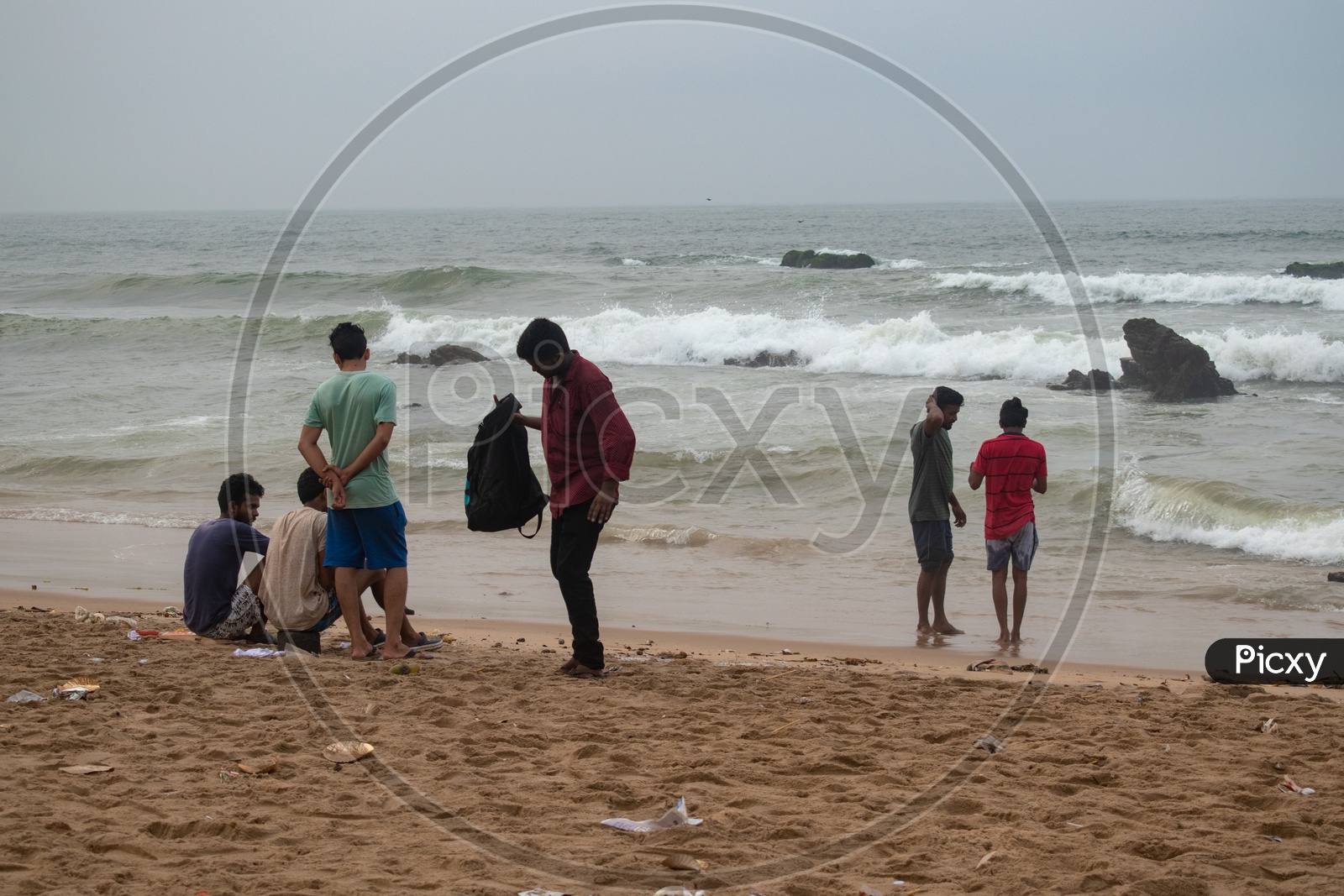 Group of young men enjoying the beach view at Rama Krishna beach (R.K.Beach), Vishakapatnam/Vizag.