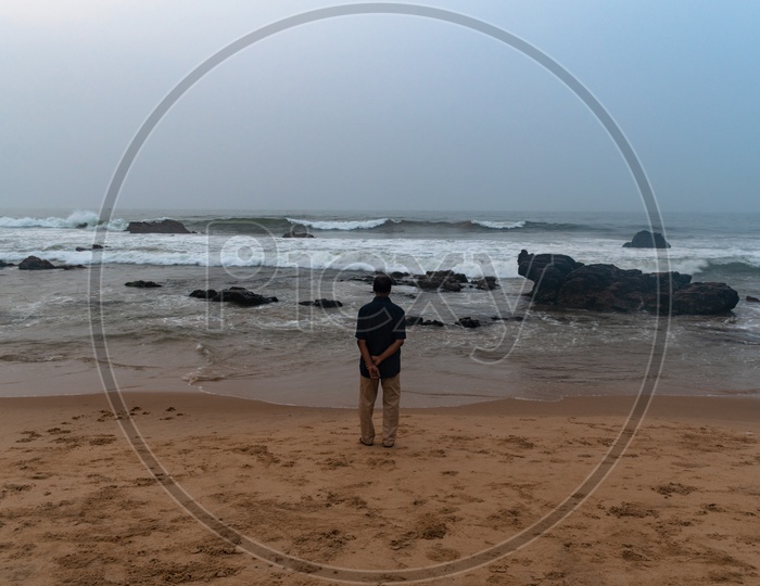 Person/old man standing at the shore and enjoying the beach view at Rama Krishna beach (R.K.Beach), Vishakapatnam/Vizag.