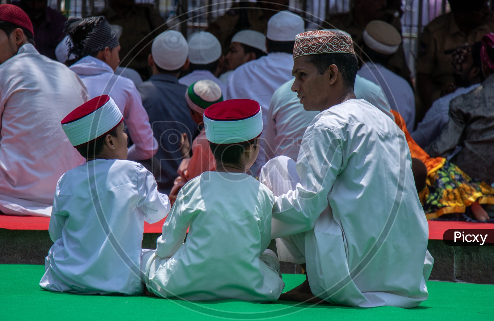 A Muslim  man With His sons At Alvida Jumma
