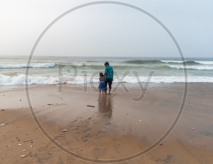 Father and Daughter enjoying the beach view at Rama Krishna beach (R.K.Beach), Vishakapatnam/Vizag.