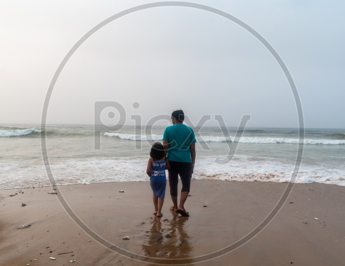 Father and Daughter enjoying the beach view at Rama Krishna beach (R.K.Beach), Vishakapatnam/Vizag.