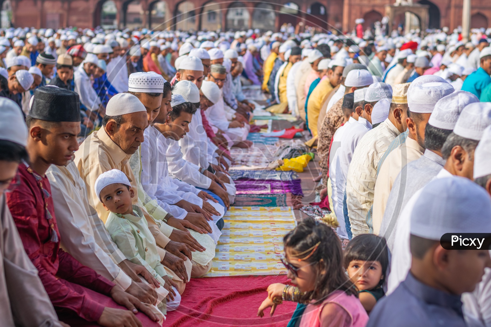 Men and a child Praying Namaz on the day of Eid-ul-Fitr (End of the holy month of Ramadan) at Jama Masjid, Delhi
