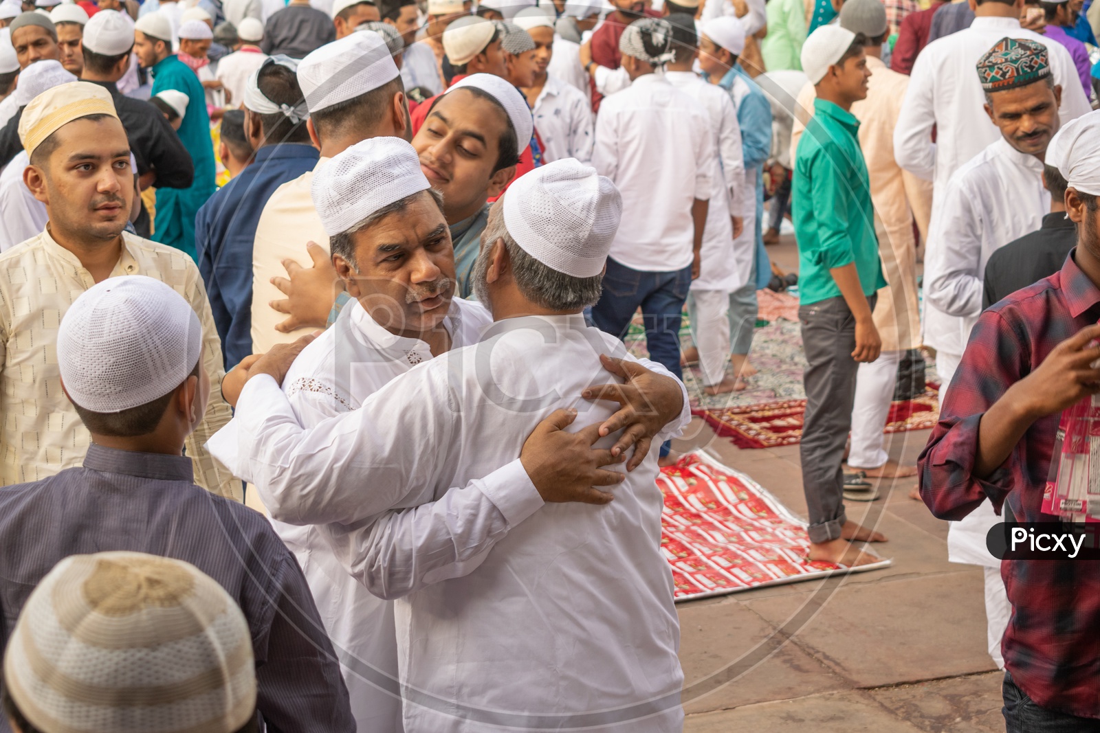 Men hugging each other after the Namaz on the day of Eid-ul-Fitr (End of the holy month of Ramadan) at Jama Masjid, Delhi
