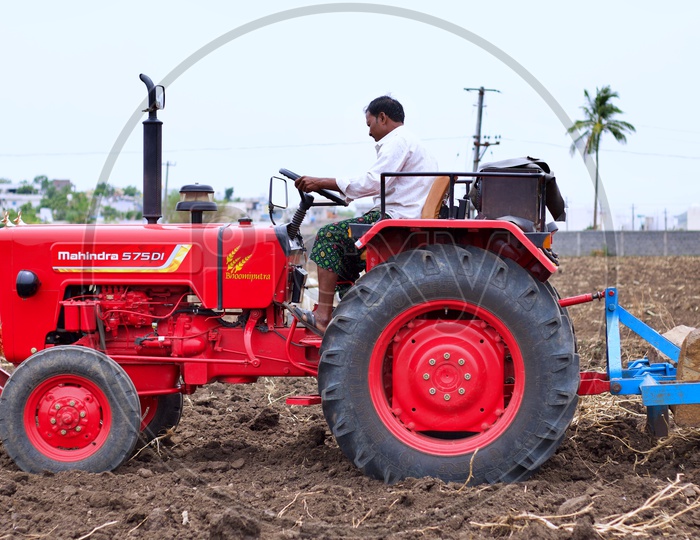 Farmer ploughing his farm with Mahindra 575DI tractor.