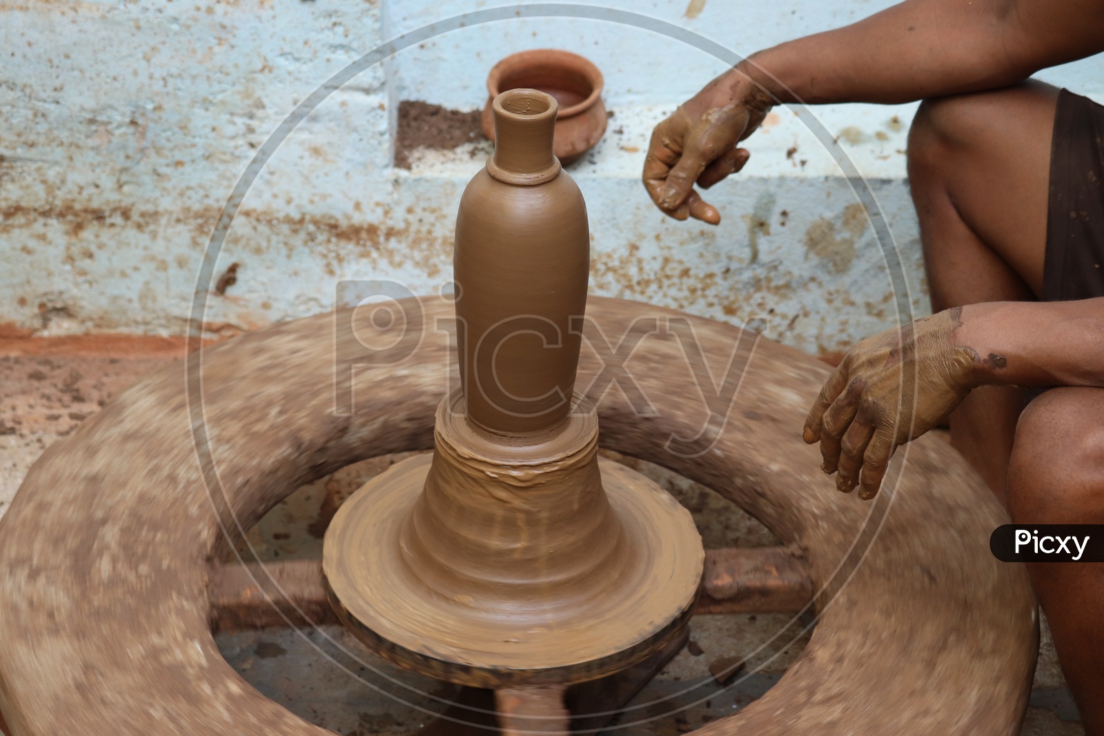 A Professional Potter Sculpting The Clay Pots With Potter Wheel  or Pottery