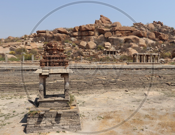 Old Ruins Of  Temple Tank In Hampi With Temple Mandapas