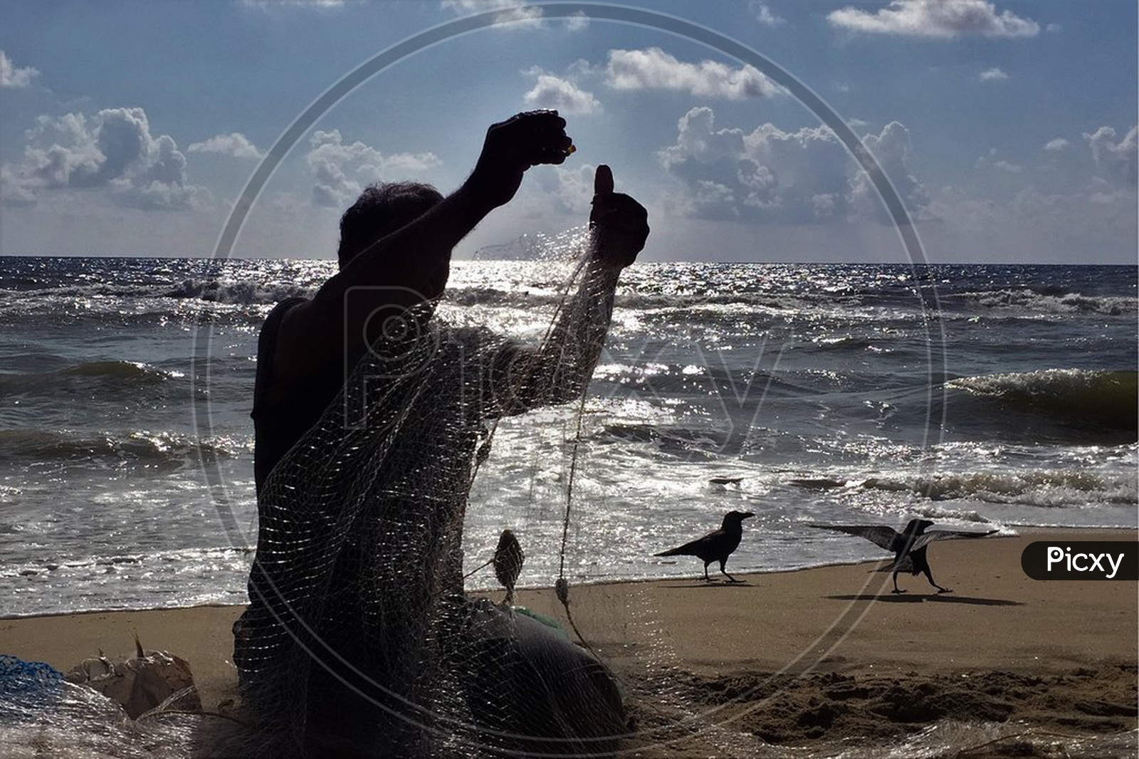 A Fisher Man  With Fishing Net On a Beach