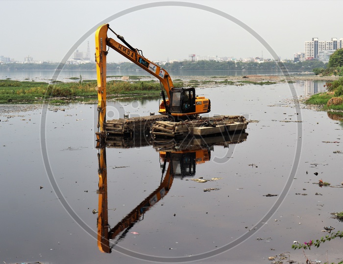A JCB Working On The Hussain Sagar lake At Necklace