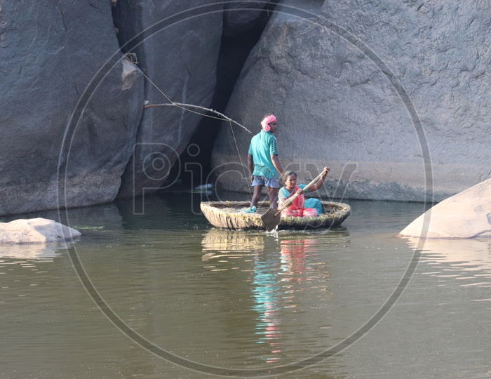 Coracle Boating On Tungabadra River  Between The Rocks In Hampi